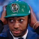 Kentucky's James Young dons a Celtics cap after being selected as the 17th overall pick.