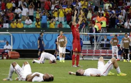 Exhausted US players around him, Belgium?s Axel Witsel celebrated at the end of  extra time.
