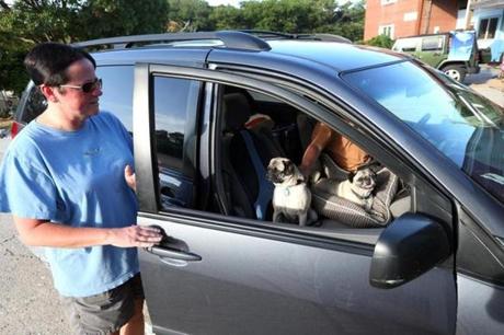 Susan Holbrook climbs into her car with husband Steve Kozlowski and her two pugs to leave Hatteras Island, N.C., on Wednesday. Moments earlier Dare County had called for a mandatory evacuation because of approaching Hurricane Arthur.
