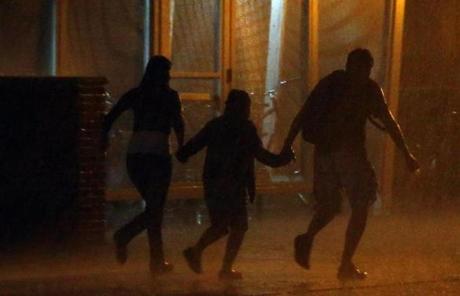 People ran through a downpour in Cambridge after the fireworks display.
