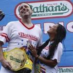 Joey Chestnut and his fiance Neslie Ricasa pose for pictures after the 98th annual Nathan's Famous Hot Dog Eating Contest at Coney Island on July 4, 2014 in Brooklyn.