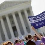 A demonstrator held up a sign outside the Supreme Court in Washington on the day the court decided in the Hobby Lobby case to relieve businesses with religious objections of their obligation to pay for women's contraceptives.