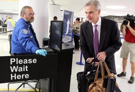 Transportation Security Administration agent Kevin Effan, left, allowed a screened passenger to board his American Airlines flight via the TSA PreCheck lane at Lambert-St. Louis International Airport.
