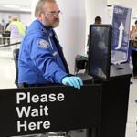 Transportation Security Administration agent Kevin Effan, left, allowed a screened passenger to board his American Airlines flight via the TSA PreCheck lane at Lambert-St. Louis International Airport.