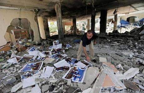 A man searched rubble at a center for disabled people in Gaza, after an Israeli strike.
