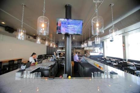Oysteria has kept the rectangular bar in the dining room from Olives but replaced the wood top with white marble.
