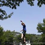 Mike Jones, 31, of Brookline balances on a railing during an outdoor Parkour class in Somerville.