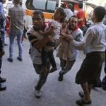 Palestinian medics carried children wounded in the strike on a compound housing a UN school in Gaza on Thursday. 