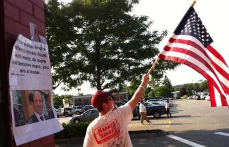 Conor Keilty, a Market Basket employee, waved an American flag.
