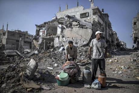 Palestinian men gathered things they found in the rubble of destroyed buildings Sunday in the Shejaiya residential district of Gaza City.


