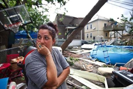 Barbara Cardone surveyed the damage to her yard and home on Taft Street in Revere on Monday. 
