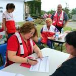 At the American Legion on Broadway, Red Cross volunteer Michelle Santucci took information from resident Renee Bowermaster, who needed assistance after her home on Rose Street was damaged.