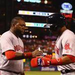 David Ortiz congratulates Yoenis Cespedes after the outfielder scored what turned into the game-winning run. 