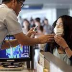 A quarantine officer checked the body temperature of a passenger at Incheon International Airport in South Korea.