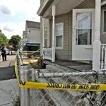 Police tape was outside the house at 105 Andrews St. in Lowell were the brothers were found.