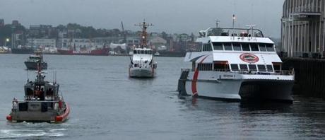 The Provincetown IV, right, was escorted into port by Coast Guard vessels.

