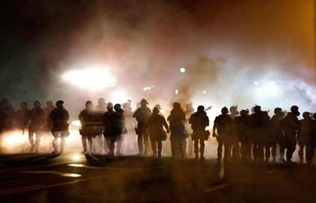 Police advanced through smoke Wednesday night in Ferguson.
