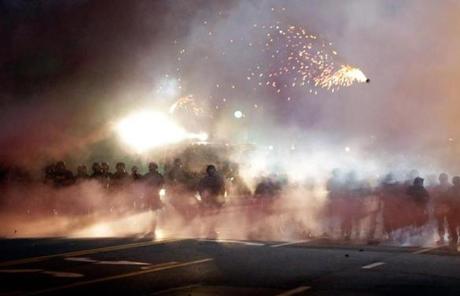 An explosive device deployed by police flew through the air in Ferguson, Mo., Wednesday night.
