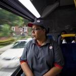 Enid Lugo, 52, on the bus this week to her fast-food job in Holyoke, says she gets no paid vacation time.