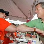 Charlie Baker greeted volunteer Samantha Morin before buying a kielbasa sandwich at the Lowell Polish Cultural Committee. 