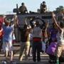 Protesters raised their hands in front of police atop an armored vehicle in Ferguson, Mo., on Wednesday.