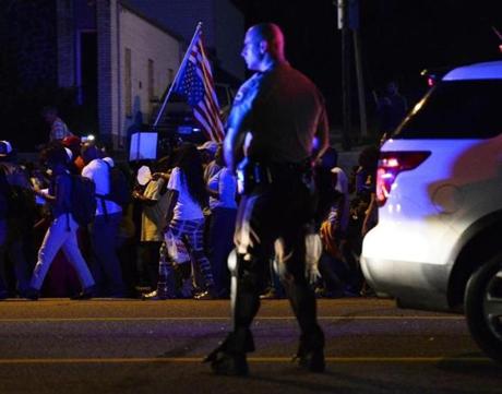 Officers and protesters were on the streets in Ferguson, Mo., Monday night.
