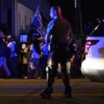 Officers and protesters were on the streets in Ferguson, Mo., Monday night.
