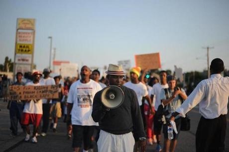 Protesters walked on West Florissant Avenue in Ferguson, Mo., Tuesday.
