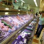 A customer looked at the seafood on display at the Market Basket in Burlington.