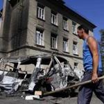 A man on Sunday walked past vehicles destroyed in recent shelling in the eastern Ukrainian town of Ilovaysk. 