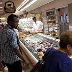 Customers examined meat products at the Burlington Market Basket.