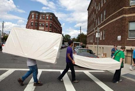 Students Avdit Kohli, Yan Olshevskyy, and Yajur Gulati carried mattresses down Commonwealth Avenue to their new apartment in Allston Monday.
