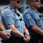 Police officers wore what appeared to be body cameras as they held the line against protesters gathered at the police station during a rally in Ferguson, Mo., last month.