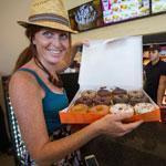 Patron Caila Ball-Dionne shows her purchase at a newly opened Dunkin' Donuts store in Santa Monica, Calif.