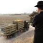 An ultra-Orthodox Jewish man watched as a truck transported Iron Dome anti-missile batteries in the southern city of Ashdod on Nov. 17, 2012.