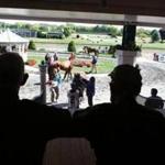 Two Fitchburg residents watched the activity before a race at Suffolk Downs, which is expected to close after the Gaming Commission chose rival Wynn Resorts for a Boston-area casino license.