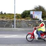 A motorist passed by a poster of Martin Walsh in Ireland.