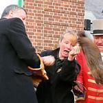 In this February image taken from video, New York Mayor Bill de Blasio (left) winced as a groundhog broke free and dropped to the stage during the 2014 Groundhog Day ceremony at the Staten Island Zoo.