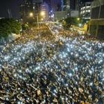 Holding cellphones aloft in a display of solidarity, demonstrators defied calls to disperse and filled streets Monday in the semiautonomous Chinese territory. A police crackdown the day before appeared only to spur more people to join the prodemocracy cause. Protesters are balking at China?s plan to control the selection of candidates for Hong Kong?s elections in 2017.