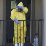 A hazardous materials worker took a break from cleaning an apartment in Dallas, where an Ebola patient stayed last week.