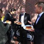 Michael Walsh (center) and Patrick Kim (right) stopped by a barbecue held at Rockland Trust?s Davis Square branch last month.