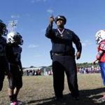 Superintendent in Chief William Gross made a coin toss to start a Boston Raiders Pop Warner football game at Franklin Field. Gross is the department?s first black superintendent in chief.