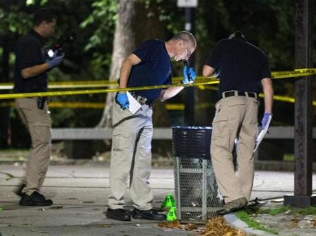 Investigators checked a trash can at Boston Common following the stabbing of two park rangers.

