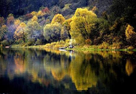 Autumn leaf colored trees are reflected in the waters of Lake Solina in Chrewt, Poland, Oct.12. Lake Solina is an artificial lake in the Bieszczady Mountains region. 
