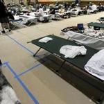 Cots lined the basketball court at the South End Fitness Center, a temporary shelter for former Long Island residents.