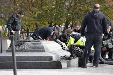 Emergency personnel tended to a soldier shot at the National Memorial near Parliament Hill in Ottawa on Wednesday.

