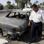 An Iraqi traffic police officer inspected a car destroyed by the Blackwater security detail in Nisour Square in Baghdad.