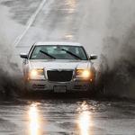 Cars traversed flooded roads in Peabody.