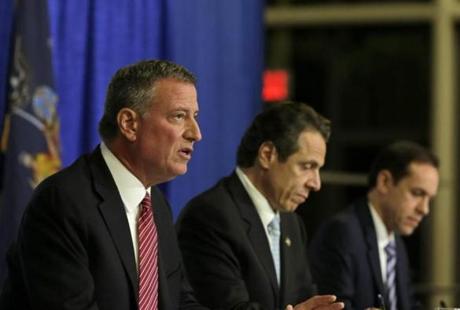 A panel, including New York Mayor Bill de Blasio (left) and Governor Andrew Cuomo (center), addressed the status of Ebola patient Craig Spencer at Bellevue Hospital in New York. 
