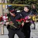 Police officers brought flowers to the Canadian War Memorial in downtown Ottawa Thursday, the spot where a soldier was fatally shot on Wednesday.
